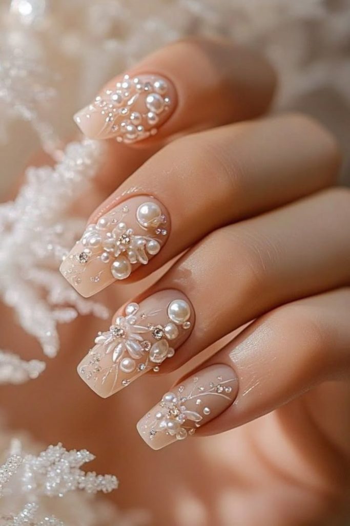 Champagne Pearl Nails with Elegant Embellishments.