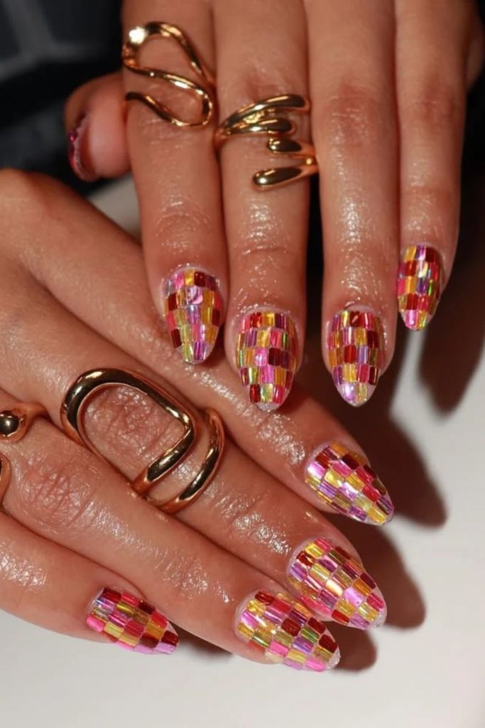 Checkerboard disco nails with reflective geometric patterns.