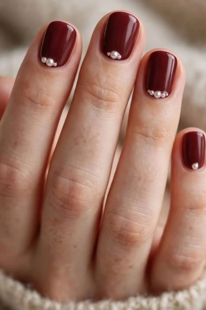 Cherry mocha nails with pearl accents.