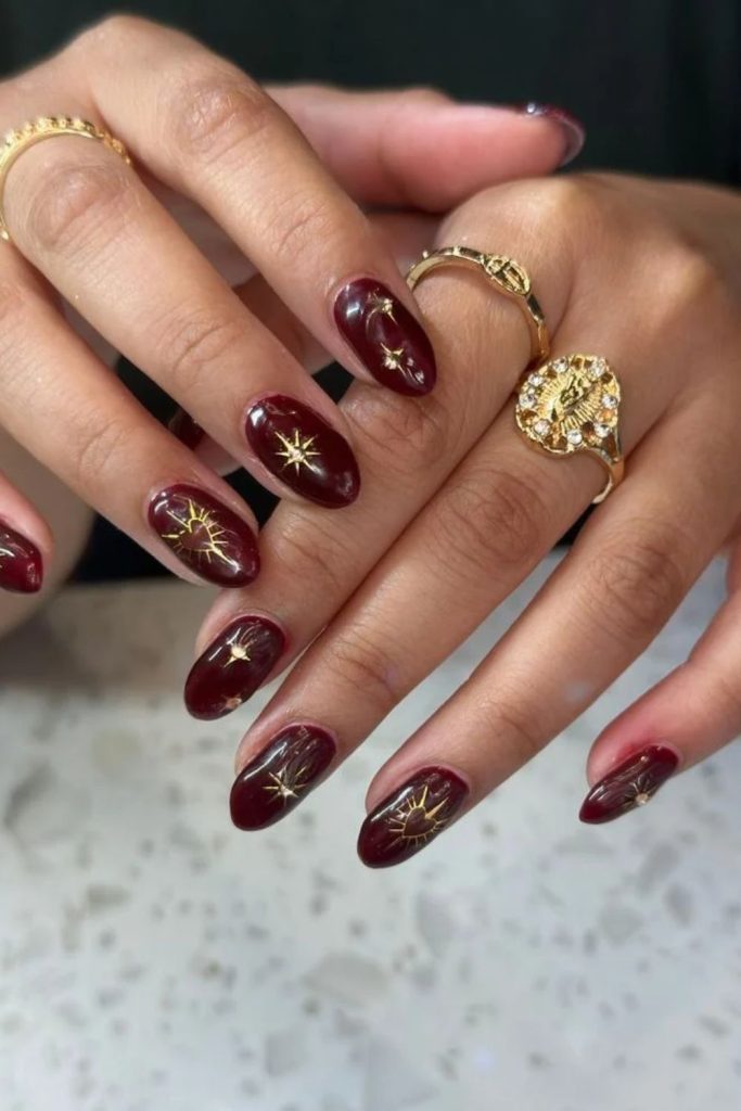 Cherry mocha nails with golden stars.