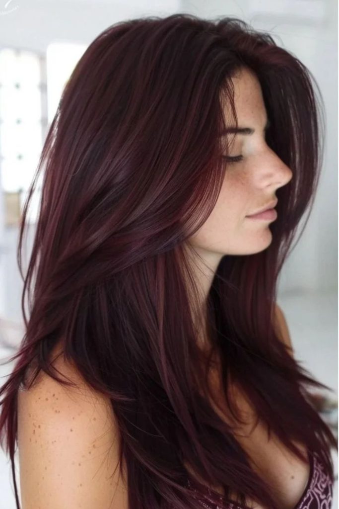 Cinnamon wine ribbons through burgundy hair.