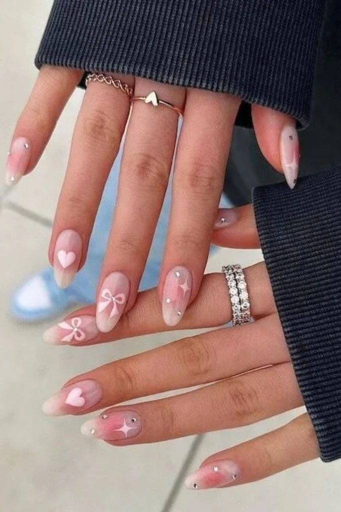 Pink aura coquette nails with tiny hearts.