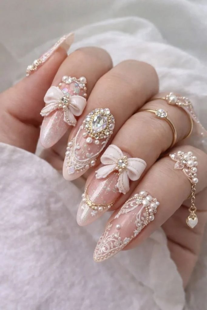 Rhinestone coquette nails featuring sparkling bow designs.