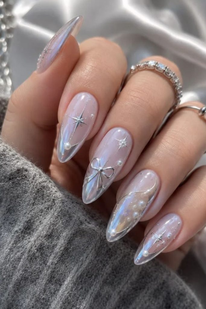 Silver glitter coquette nails with pink polish.