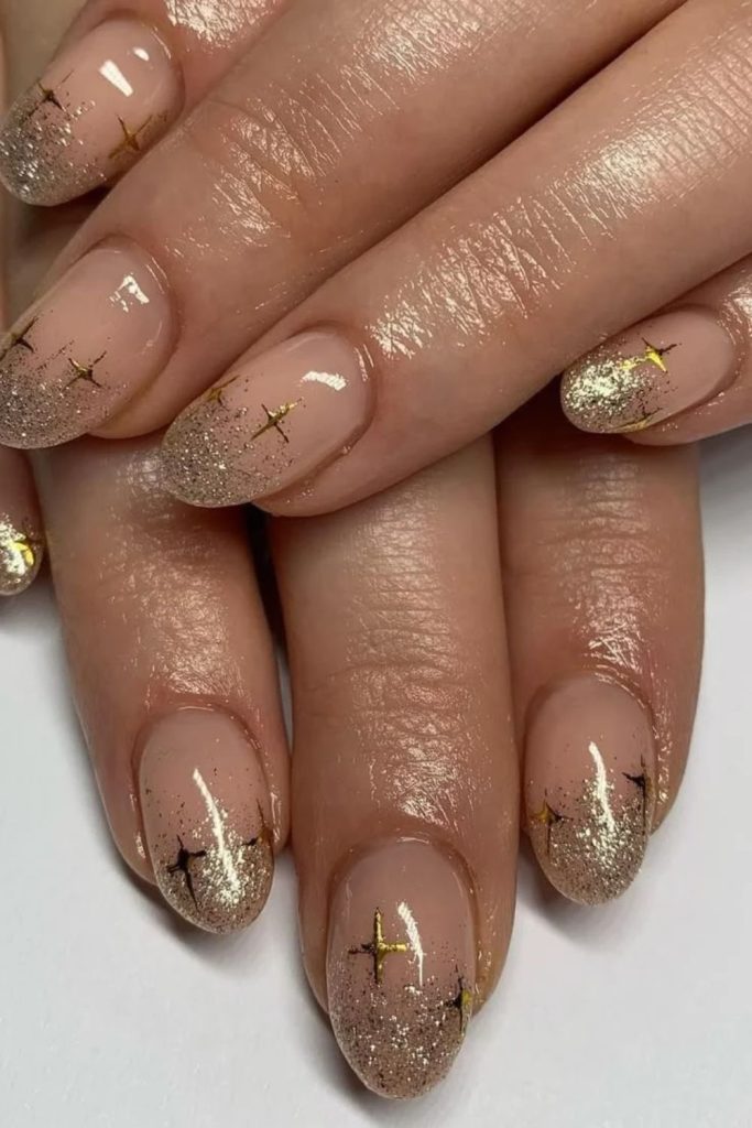 Starry disco nails with shimmering celestial decorations.
