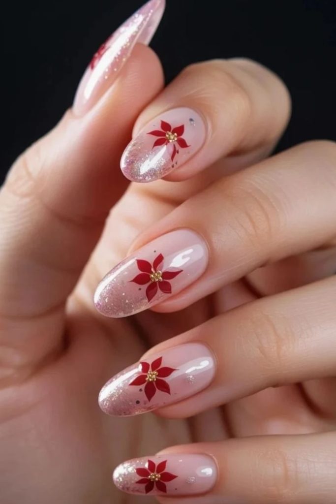 Festive glitter nails with vibrant poinsettia designs.