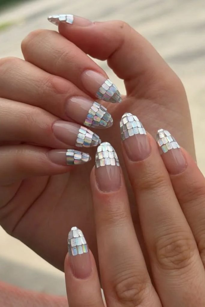 French tip disco nails with silver glitter.