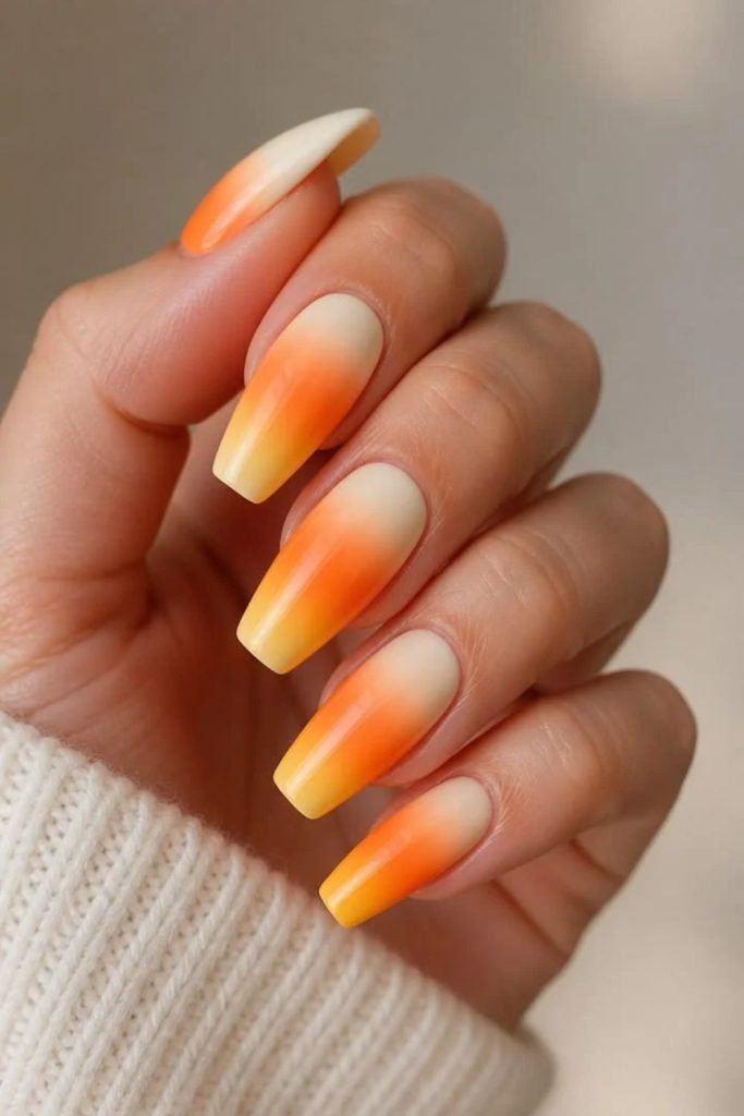 Glossy candy corn ombre Halloween manicure.
