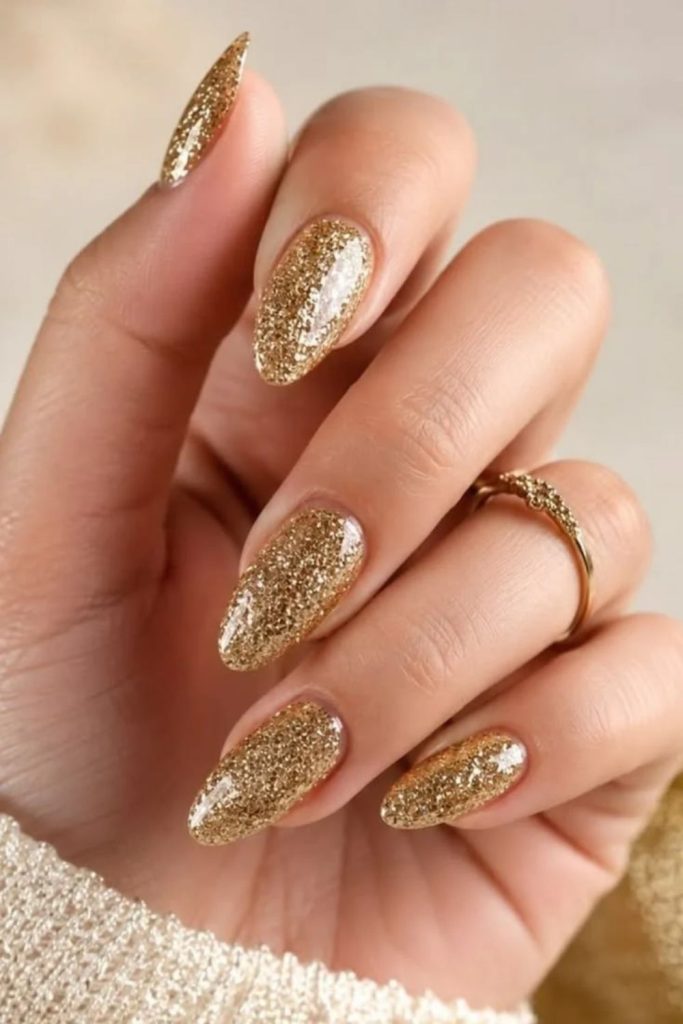 Gold disco ball nails with luxurious metallic shine.