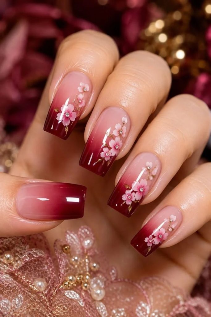 Glitter ombre nails featuring festive poinsettia flowers.