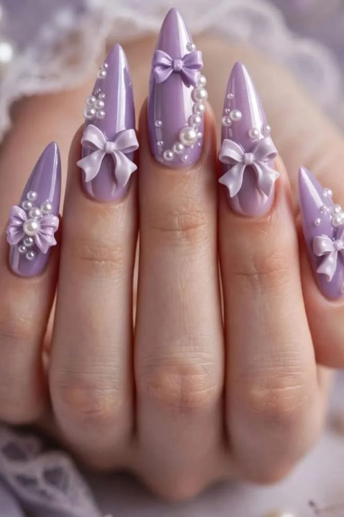 Lavender coquette nails with tiny white ribbons.