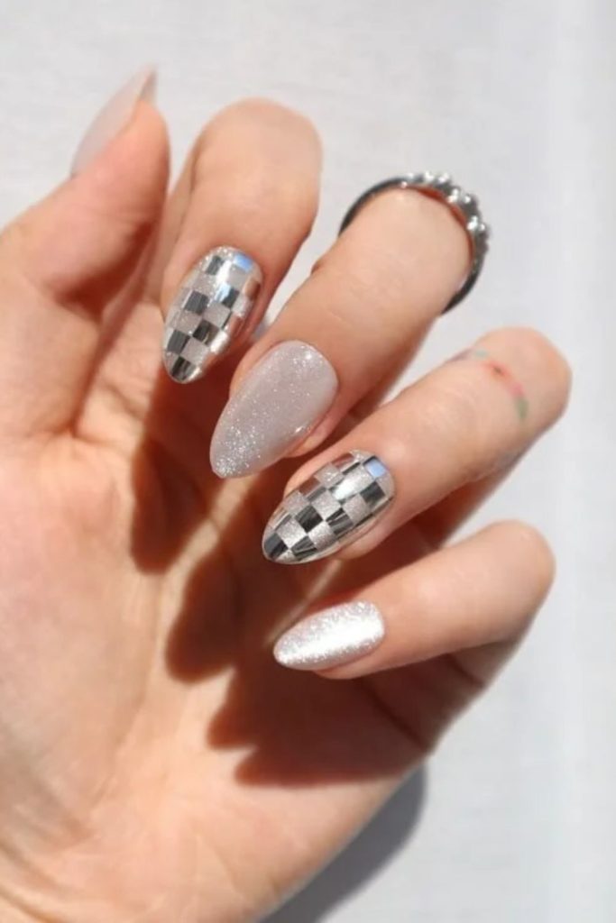 Minimalist disco nails with subtle silver accents.