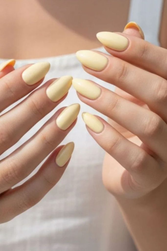 Pastel butter yellow cloud nail art.