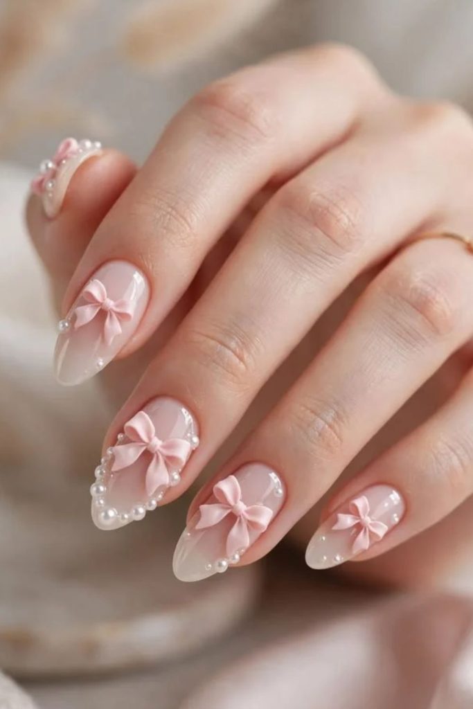 Pearl-adorned coquette nails with elegant accents.