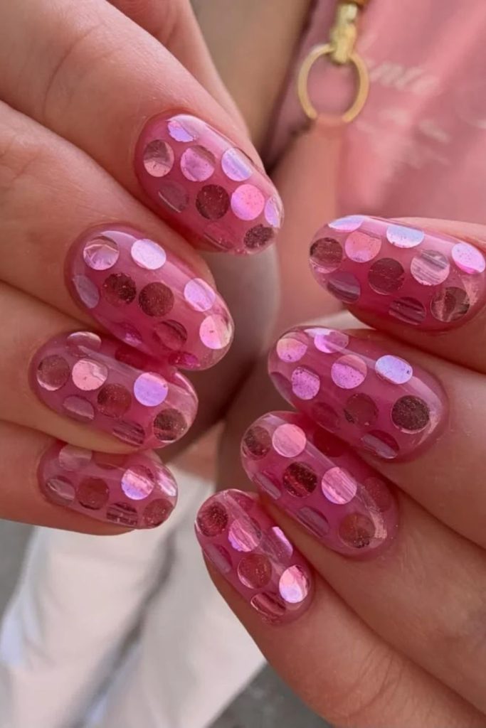 Pink disco ball nails with holographic silver accents.