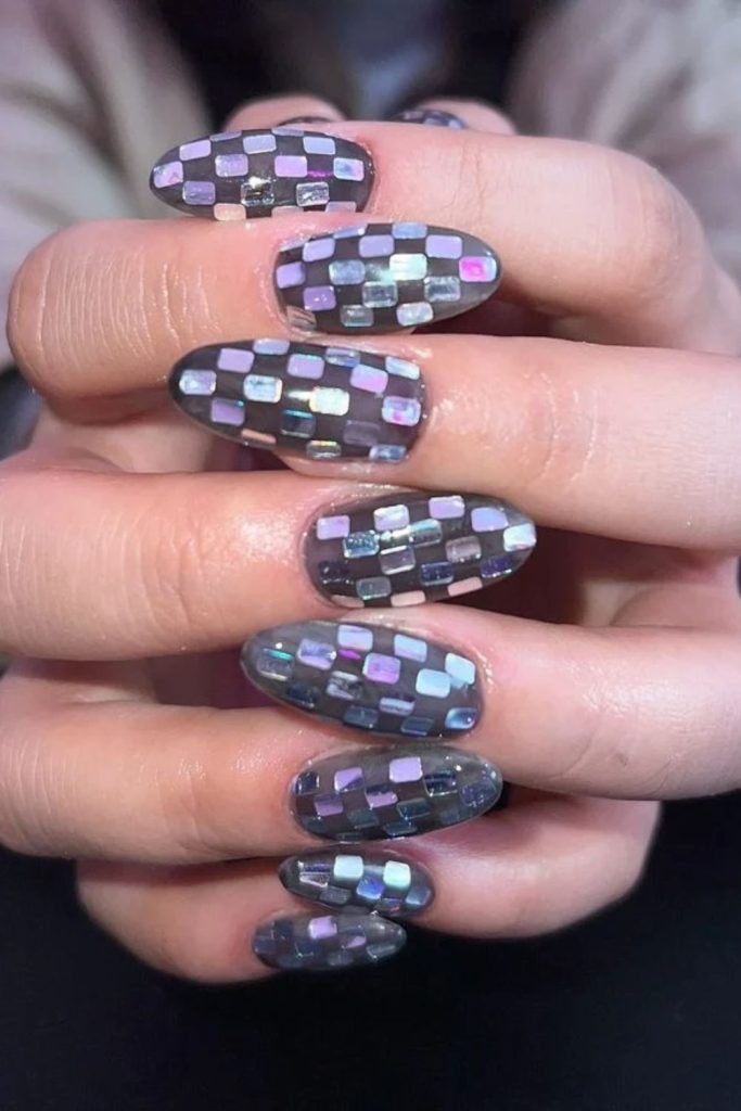 Purple disco nails with shimmering mirror squares.