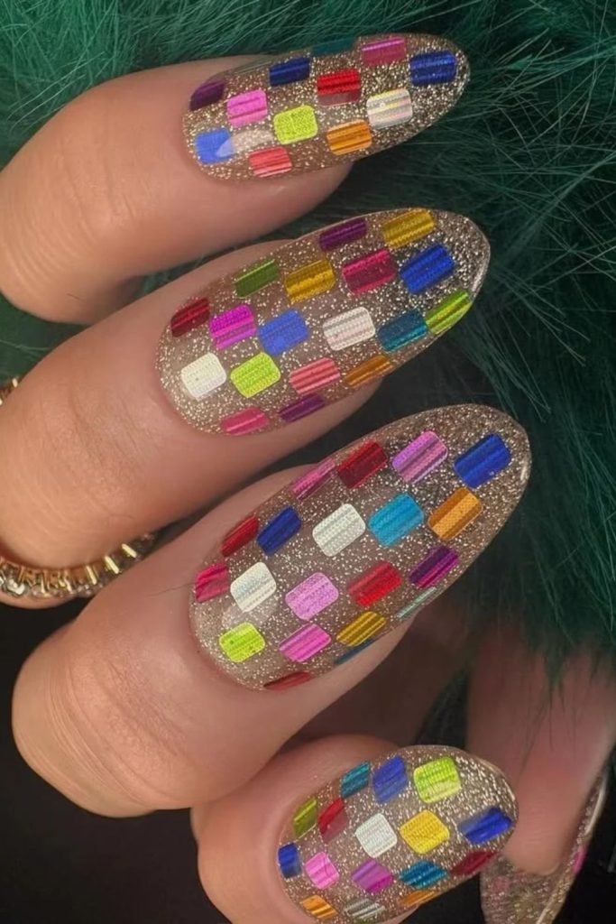Rainbow holographic disco nails with colorful reflections.