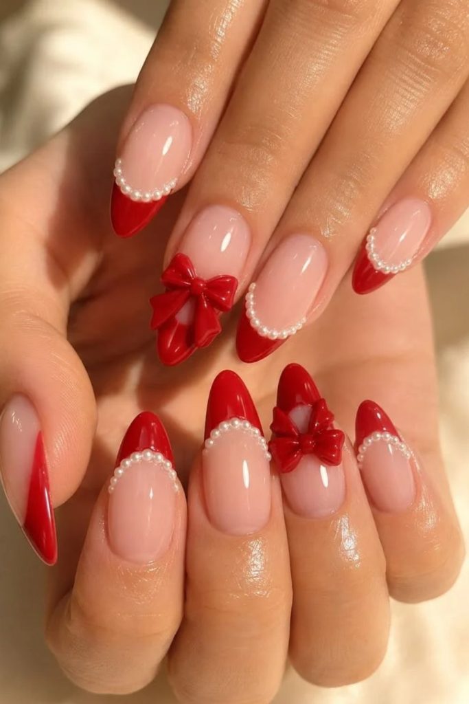 Red French coquette nails with tiny bows.