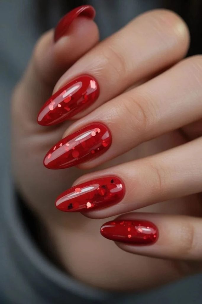 Red disco nails with bold metallic accents.