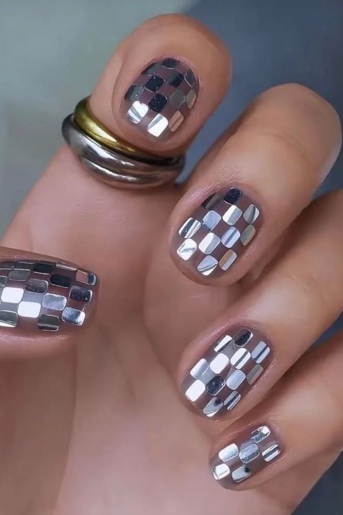 Short square disco nails with subtle silver shimmer.