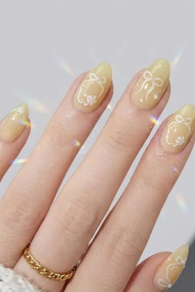 Butter yellow bow coquette nail design.